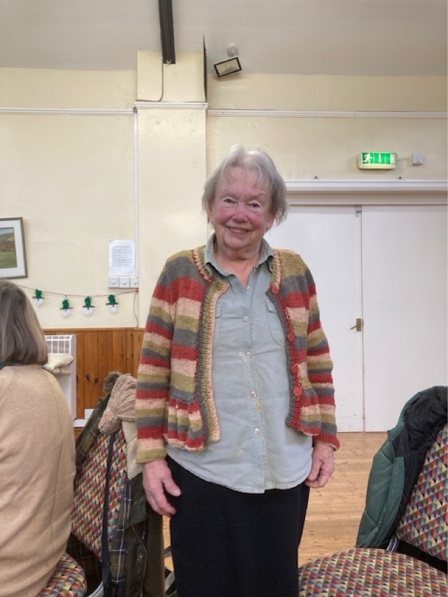 Valerie wearing a cardigan she has knitted